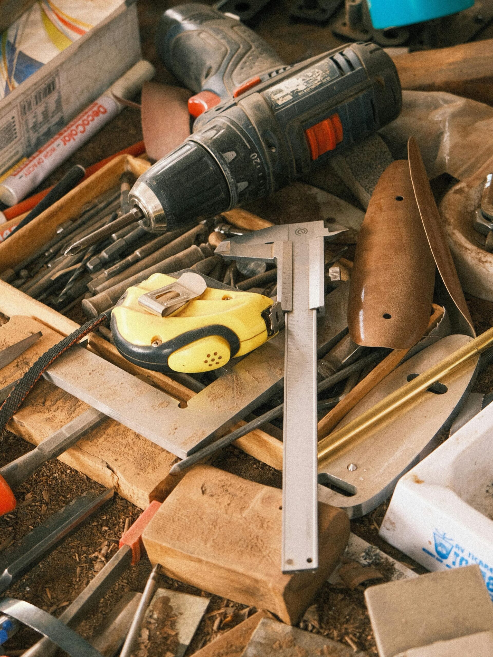 A collection of carpentry tools on a messy workbench showcasing craftsmanship and work in progress.